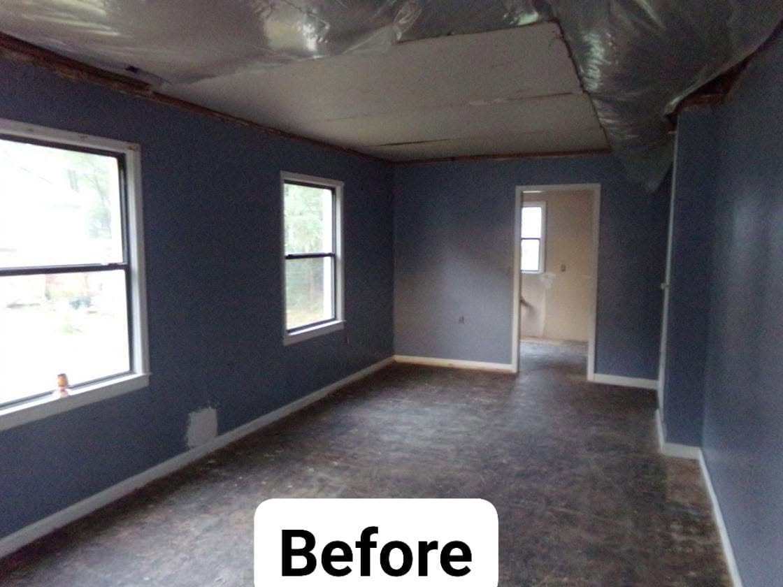 Back room before: peeling ceiling, torn plastic sheeting and bare concrete floor