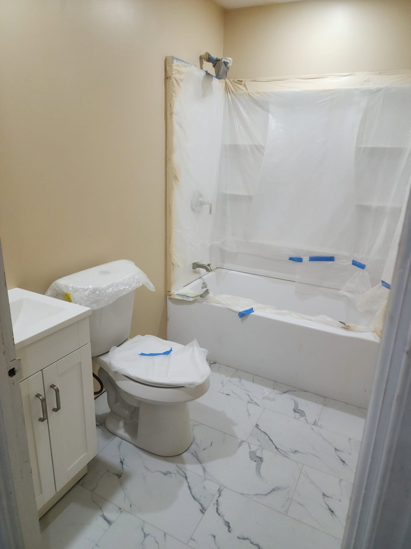Renovated bathroom with new tile, tub and vanity